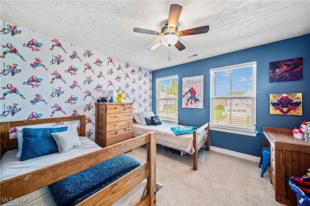 bedroom featuring ceiling fan, a textured ceiling, and light carpet