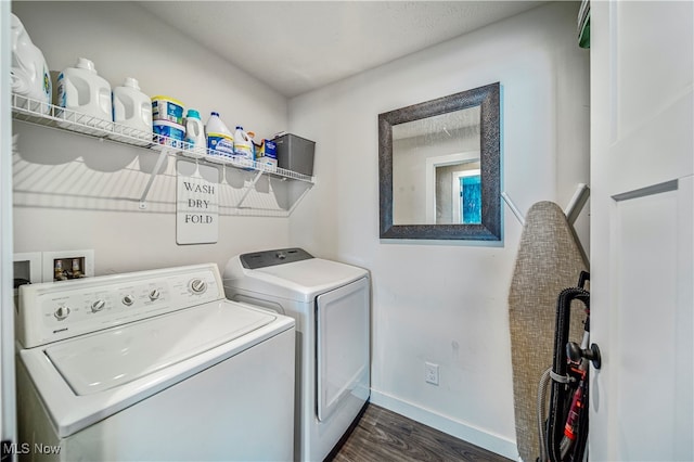 laundry room featuring dark hardwood / wood-style floors and washer and dryer