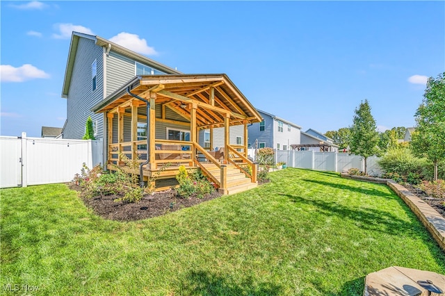 back of house with a wooden deck and a yard