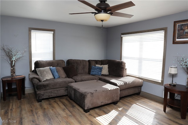 living room featuring plenty of natural light, ceiling fan, and wood-type flooring