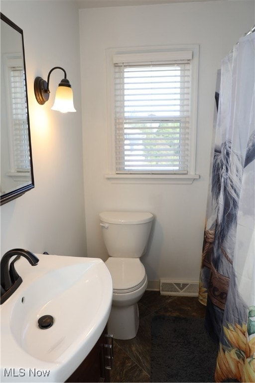 bathroom featuring sink and toilet