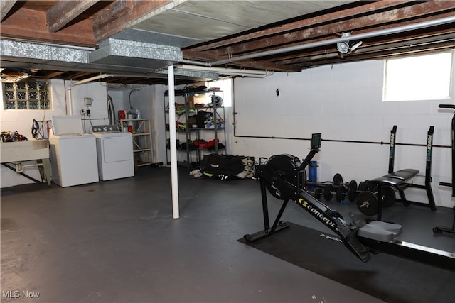 workout area with separate washer and dryer and sink