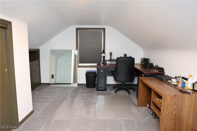 office with light colored carpet and vaulted ceiling