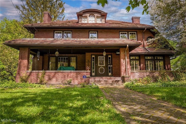 view of front of home with a front lawn and covered porch