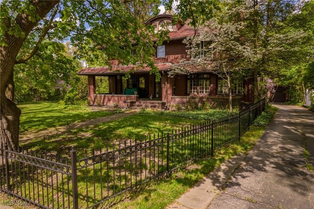 view of front facade with a front lawn and a porch