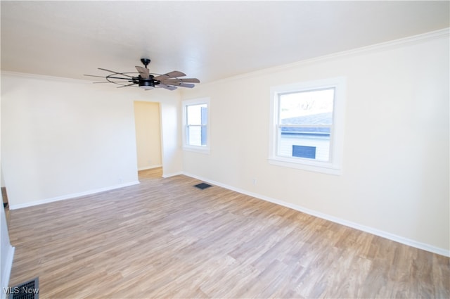 spare room with light wood-type flooring, crown molding, and ceiling fan