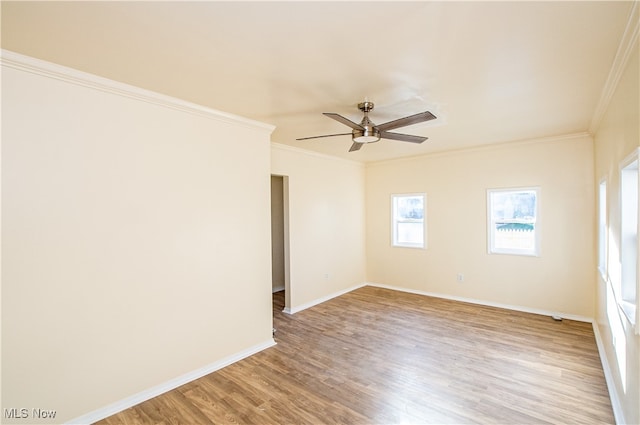 empty room with ornamental molding, ceiling fan, and hardwood / wood-style flooring