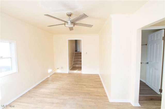 spare room featuring ceiling fan, crown molding, and light hardwood / wood-style floors