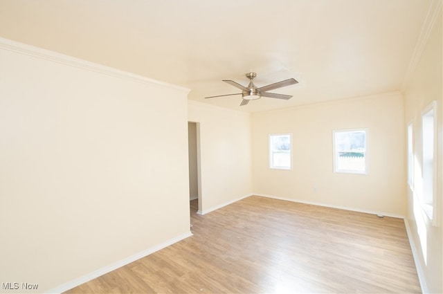 spare room featuring ceiling fan, light wood-type flooring, and ornamental molding