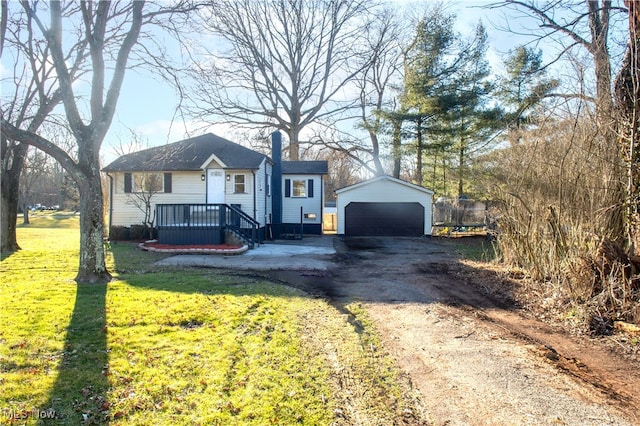 ranch-style home with a front yard, a trampoline, an outdoor structure, and a garage