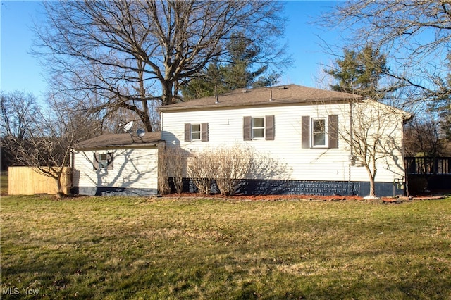 rear view of property featuring a yard