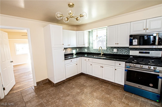 kitchen with stainless steel appliances, white cabinets, plenty of natural light, and sink