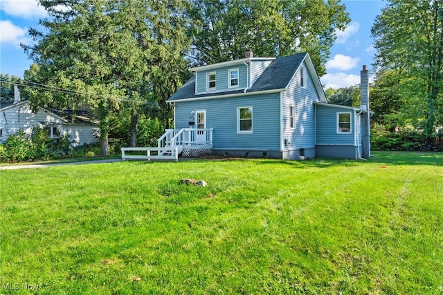 back of house featuring a wooden deck and a lawn