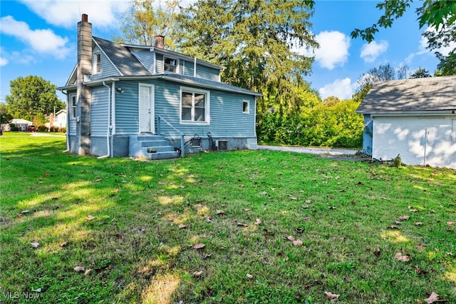 rear view of house with a lawn