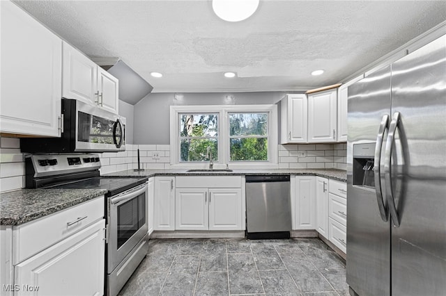 kitchen featuring stainless steel appliances, white cabinetry, and sink