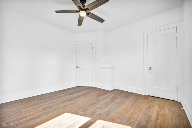 spare room featuring hardwood / wood-style floors and ceiling fan