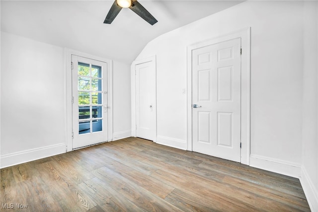 unfurnished bedroom featuring vaulted ceiling, ceiling fan, and hardwood / wood-style flooring