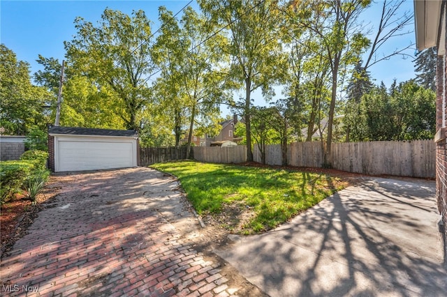 view of yard with a garage and an outdoor structure