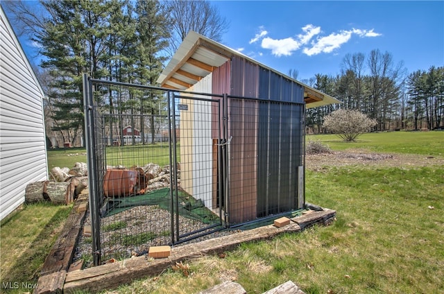 view of outdoor structure featuring a lawn