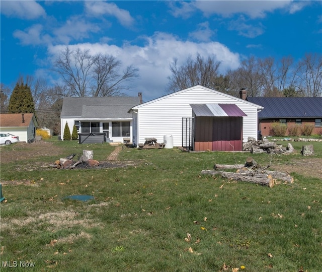 rear view of property featuring a yard