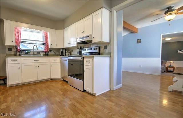 kitchen featuring appliances with stainless steel finishes, light wood-type flooring, and white cabinets