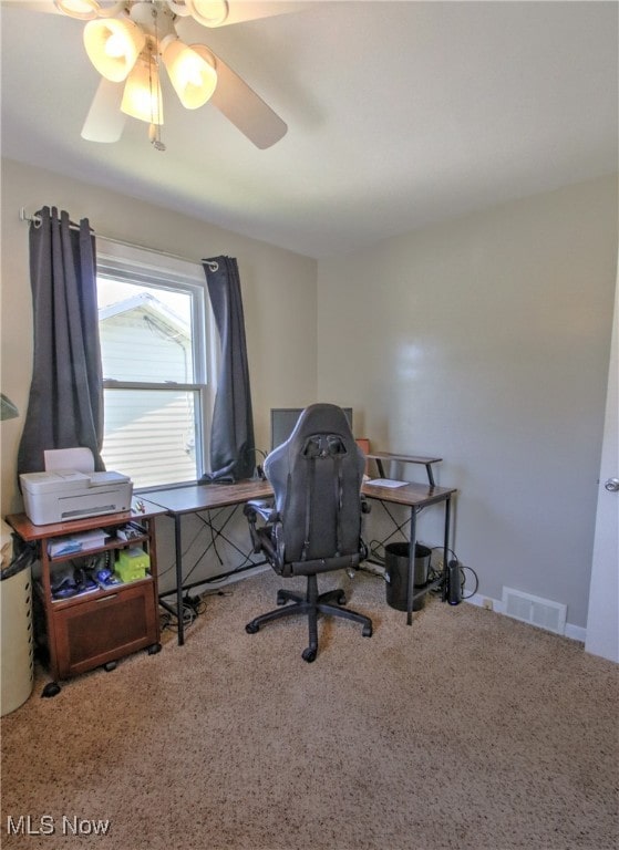 carpeted office space with ceiling fan