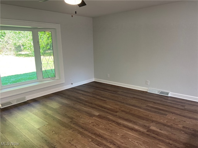 unfurnished room featuring dark wood-type flooring and ceiling fan