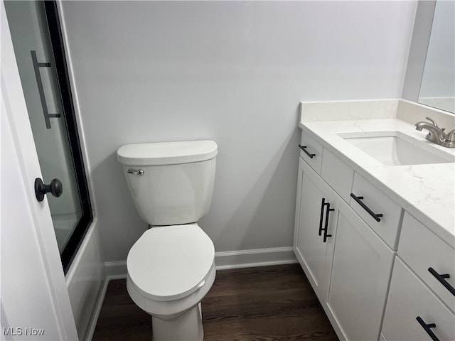 full bathroom with vanity, toilet, wood-type flooring, and tub / shower combination