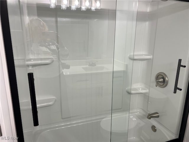 bathroom with sink and shower / bath combination with glass door