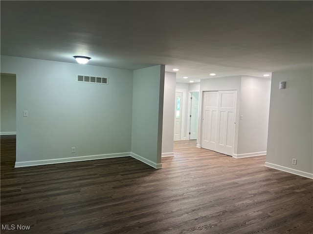 empty room with dark wood-type flooring