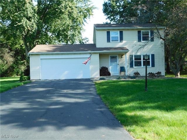 view of front of property featuring a front yard and a garage