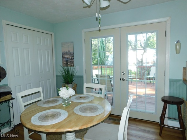 dining area featuring wood-type flooring, ceiling fan, and french doors