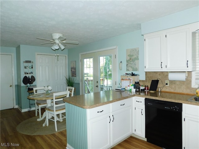 kitchen with black dishwasher, kitchen peninsula, dark hardwood / wood-style flooring, and white cabinetry