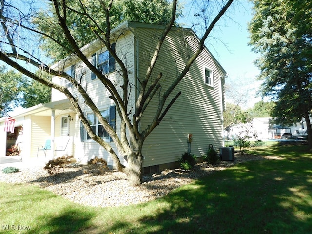 view of home's exterior with a lawn and cooling unit