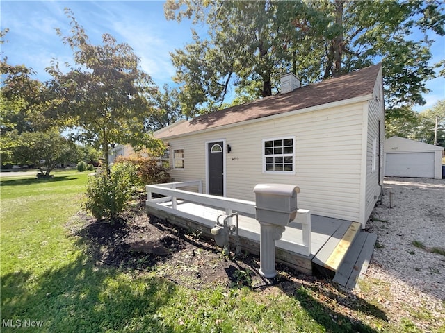 view of outdoor structure with a yard and a garage