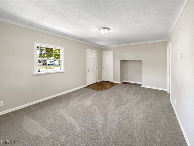 carpeted empty room with a textured ceiling and crown molding