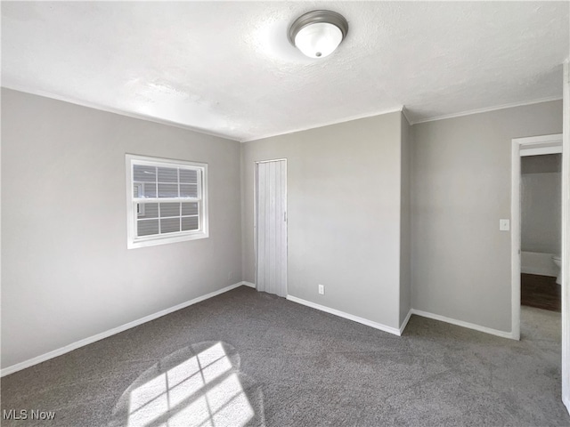 carpeted spare room with a textured ceiling