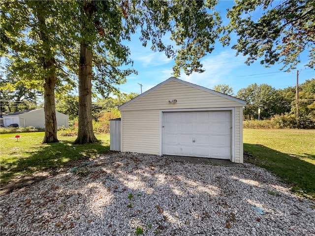 garage featuring a lawn