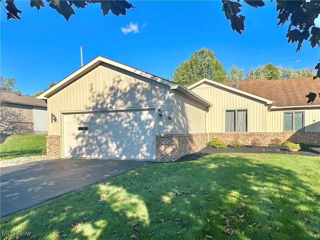 view of home's exterior with a garage and a lawn