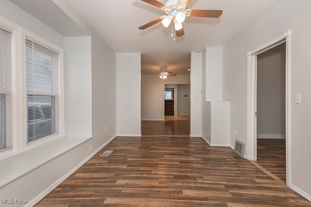 empty room featuring ceiling fan and dark hardwood / wood-style floors