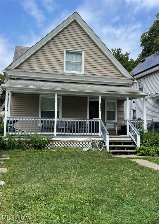 view of front facade with a porch and a front lawn