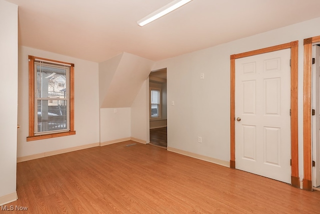 spare room with light wood-type flooring and a healthy amount of sunlight