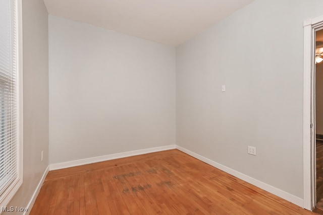 unfurnished room with wood-type flooring