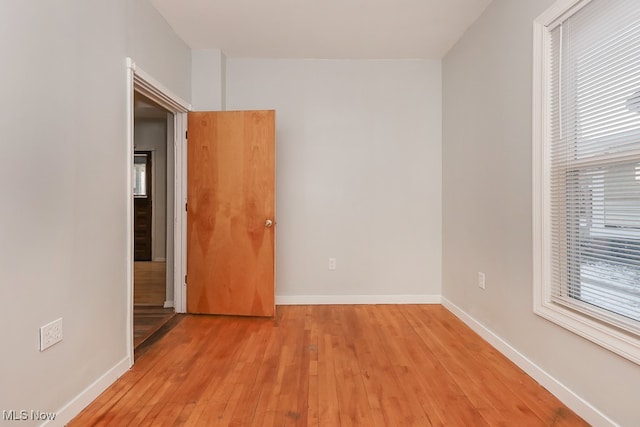 empty room featuring light hardwood / wood-style flooring and a healthy amount of sunlight