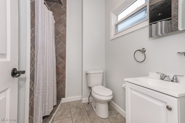 bathroom with curtained shower, vanity, and toilet