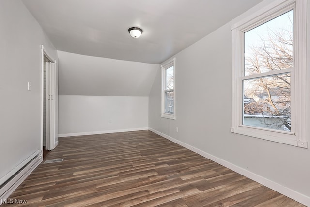 bonus room with baseboard heating, dark hardwood / wood-style flooring, and plenty of natural light