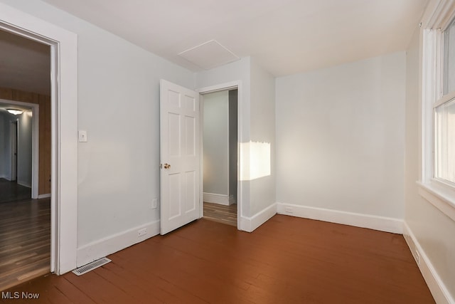 unfurnished bedroom with dark hardwood / wood-style flooring