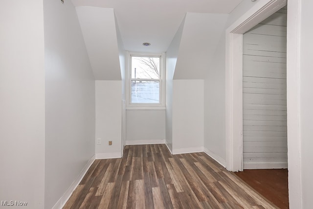 additional living space with lofted ceiling and dark wood-type flooring