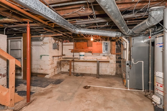 basement with gas water heater, electric panel, and heating unit