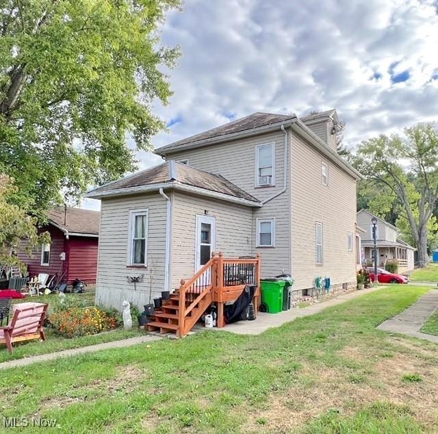 back of property with a lawn